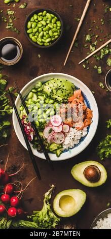 Salmon poke bowl or sushi bowl with vegetables, narrow composition Stock Photo