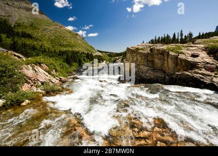 A fast flowing glacial river, rushing over rocks towards the camera in the Colorado mountains