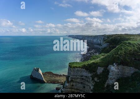 White chalk cliffs on the coast of the Atlantic Ocean. Scenic view of the coastline in Normandia in the town of Etretat in France. French coastal. Stock Photo