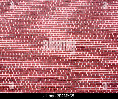 A smooth brick wall of a cold red- brown color with white joints. Textured background. Stock Photo