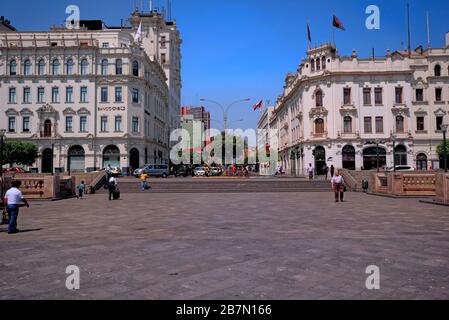 Lima, Peru - April 18, 2018: Tourists walking and talking in Plaza San Martin with buildings and steps in background. Stock Photo