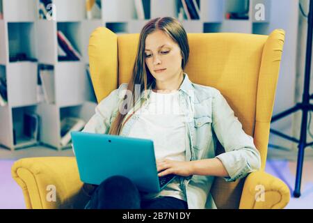 Young lady boss entrepreneur in a comfortable chair Stock Photo