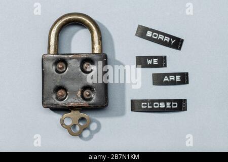 Padlock with label sorry we are closed isolated on gray background. Closed by coronavirus or covid-19 concept Stock Photo