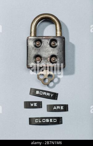 Padlock with label sorry we are closed isolated on gray background. Closed by coronavirus or covid-19 concept Stock Photo