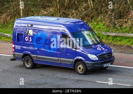 Blue Mercedes Benz G4s armoured security van driving on the M6 motorway, UK Stock Photo