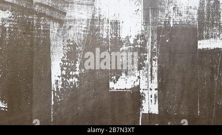 Weathered and aged concrete wall with paint, mostly peeled from black and white with vignetting. Shades of gray and white. Great modern, textured Stock Photo