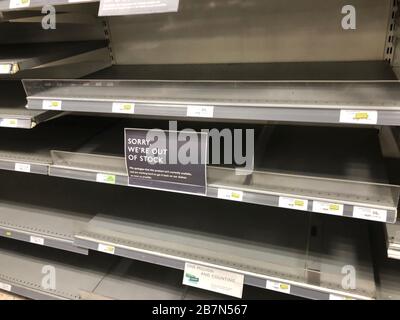 Empty shelves where toilet rolls are usually stocked in a Waitrose in Southsea, Hampshire, the day after Prime Minister Boris Johnson called on people to stay away from pubs, clubs and theatres, work from home if possible and avoid all non-essential contacts and travel in order to reduce the impact of the coronavirus pandemic. Stock Photo