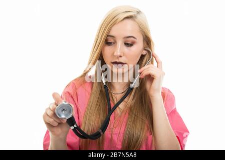 Portrait of female doctor wearing scrubs consulting with stethoscope isolated on white background with copy space advertising area Stock Photo