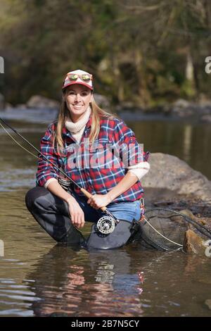 Woman Fly Fishing in River – License Images – 687511 ❘ StockFood