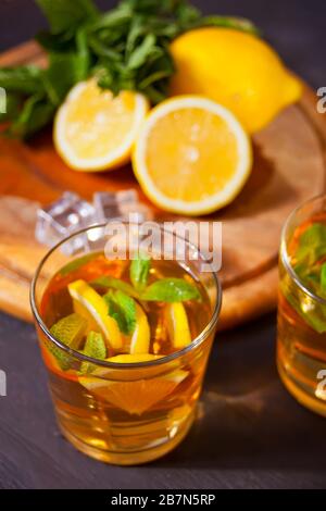 Two glasses of cold refreshment tea with ice and lemon fruit Stock Photo