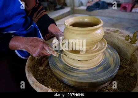 Closeup of Local woman demonstrates on making traditional clay jar called Labu Sayong or Essence Jar of Sayong inside workshop in Kuala Kangsar, Perak Stock Photo