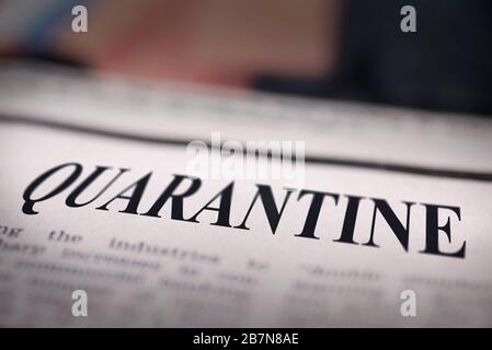 Quarantine written newspaper close up shot to the text. Stock Photo