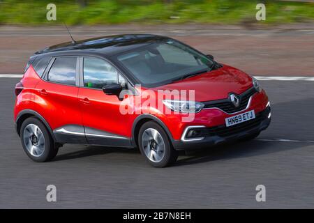 Compact red car moving fast on a busy street in downtown, Belo ...