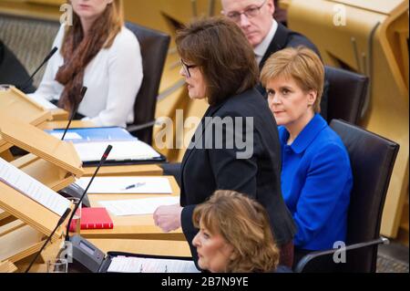 Edinburgh, UK. 17th Mar, 2020. Pictured: (in black) Jeane Freeman MSP - Cabinet Minister for Health and Sport; (in blue), Nicola Sturgeon MSP - First Minister of Scotland and Leader of the Scottish National party (SNP). Ministerial Statement: Novel coronavirus COVID-19 update Credit: Colin Fisher/Alamy Live News Stock Photo