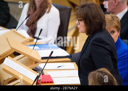 Edinburgh, UK. 17th Mar, 2020. Pictured: (in black) Jeane Freeman MSP - Cabinet Minister for Health and Sport; (in blue), Nicola Sturgeon MSP - First Minister of Scotland and Leader of the Scottish National party (SNP). Ministerial Statement: Novel coronavirus COVID-19 update Credit: Colin Fisher/Alamy Live News Stock Photo