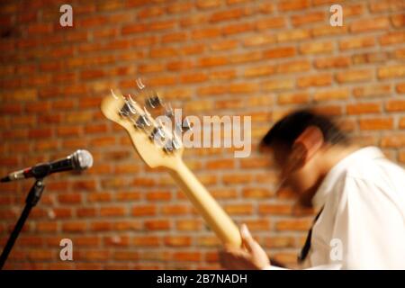 Playing electric guitar on stage. Blurred image. Stock Photo