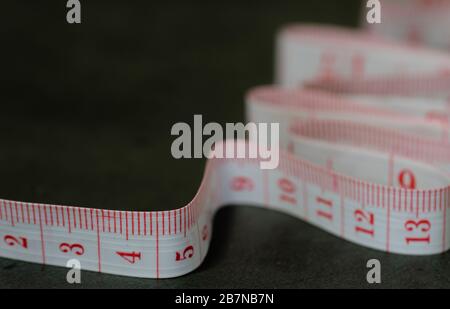 Close up tailor measuring tape on black background Stock Photo