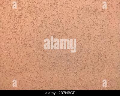 The texture of the plaster is bark beetle on the wall. Seamless pink texture. Stock Photo