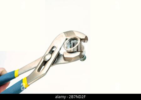 Tool for plumbing. The old coupling is clamped in a wrench. Isolated photo. Stock Photo