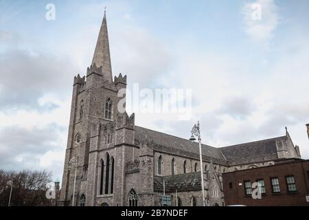 Dublin, Ireland - February 13, 2019: Street atmosphere and architecture of St Patrick's Cathedral that people visit on a winter day Stock Photo