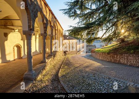 Colonnade and ancient path in the castle of Udine at sunset. Beautiful Italian architecture. Friuli Venezia Giulia, Italy. Stock Photo