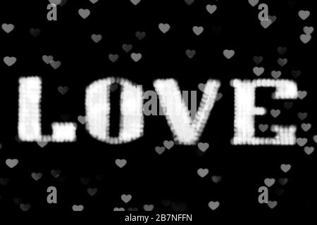 blurred text white LOVE sign LED Bokeh neon light white on background bokeh lights heart soft colorful Stock Photo
