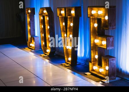 Wooden letters with small lamps, love sign lighting with bulb lights Stock Photo