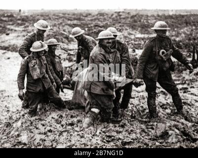 Stretcher bearers hauling a wounded soldier through the mud during the The Battle of Pilckem Ridge, the opening attack of the Third Battle of Ypres aka the Battle of Passchendaele, a campaign of the First World War, that took place on the Western Front, from July to November 1917, for control of the ridges south and east of the Belgian city of Ypres in West Flanders. Stock Photo