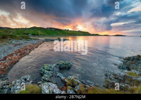 Stormy sunset sky over the rugged beach at Scourie on the Sutherland coast of Scotland Stock Photo