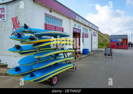 Surf School on the promenade at Saltburn by the Sea Surf Equipment and suits deckchairs and windbreaks for hire Stock Photo