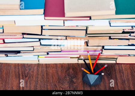 Pencils in holder and stack of books, school background for education learning concept Stock Photo