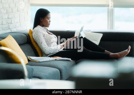Black Woman Working From Home With Laptop Computer Stock Photo