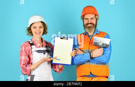 confident electrical and technician. engineers couple working together on building blueprint. work at construction site or factory. Civil engineering. industrial business partner. job and occupation. Stock Photo