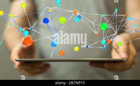 Man holding a laptop and colorful circles connected together- data share concept Stock Photo