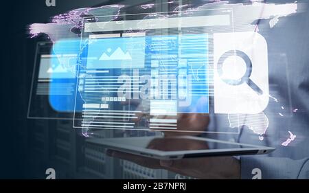Man holding a laptop with a search icon-internet searching system worldwide Stock Photo