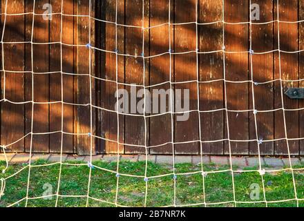 A net against a wood background. Stock Photo