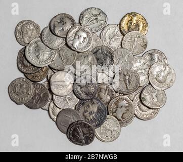 Antique Roman coins, small pile of cash on white background Stock Photo