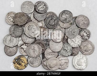 Antique Roman coins, small pile of cash on white background Stock Photo