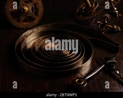 Steampank concept. Old rusty parts of mechanical watch with metal spring. Stock Photo