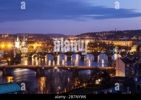 Prague cityscape at night. Classic panoramic view of the illuminated bridges across the Vltava River