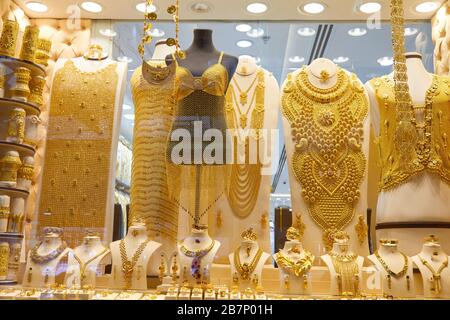 DUBAI, UNITED ARAB EMIRATES - NOVEMBER 21, 2019: Dubai gold souk market window with jewellery, necklaces, dress and luxury accessories