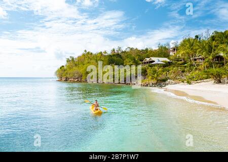St Lucia caribbean sea, young guy on vacation at the tropical island Saint Lucia, men in swim short near the beach Stock Photo