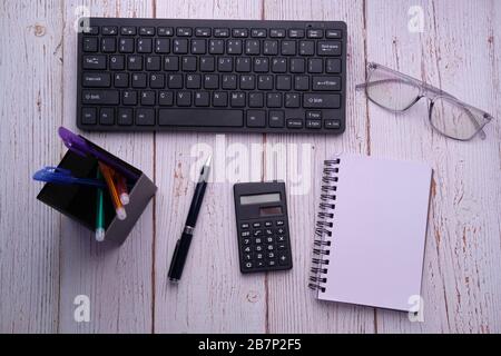 top view of calculator, notepad and pen on pink background  Stock Photo