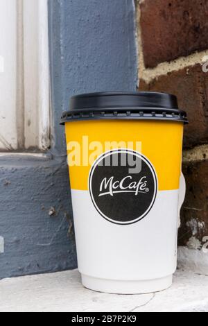 A McDonalds McCafe disposable paper coffee cup left on a window cill. Stock Photo