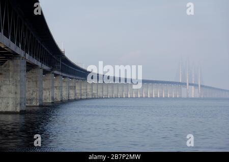 A low perspective of the Oresund bridge stretching out to the sea and the fog Stock Photo