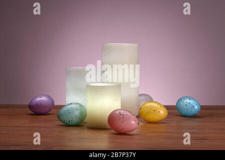 Glowing Wax Candles and Easter Eggs Stock Photo