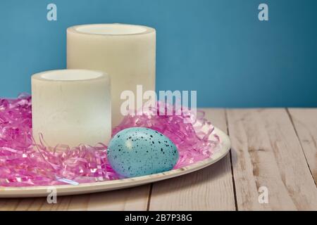 Pair of Glowing Wax Candles and Easter Egg Stock Photo