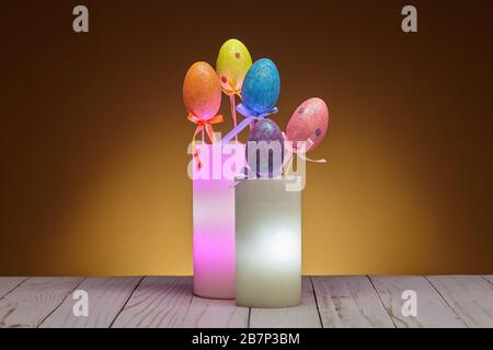 Pair of Glowing Wax Candles with Easter Eggs Stock Photo