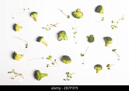 Broccoli and micro green on white background. Creative flat lay. Vegetables pattern. Stock Photo