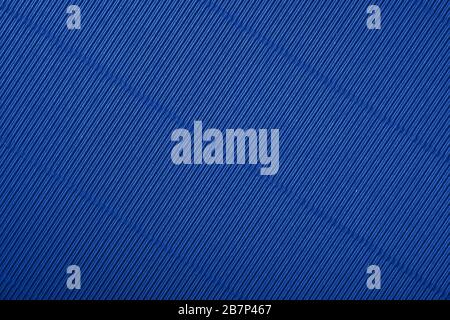 Close up diagonal background pattern texture of indigo blue corrugated packaging cardboard Stock Photo
